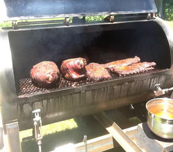 Different foods cooking on the RealSmoker smoker